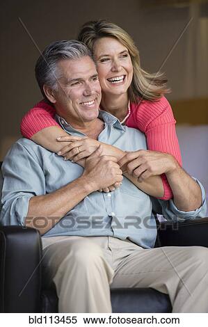 Caucasian couple hugging in armchair View Large Photo Image Stock Photography - Caucasian couple hugging in armchair. Fotosearch