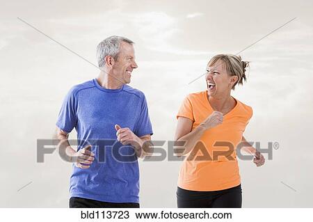 Caucasian couple jogging together View Large Photo Image Stock Image - Caucasian couple jogging together. Fotosearch