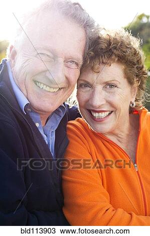 Caucasian couple smiling outdoors View Large Photo Image Stock Image - Caucasian couple smiling outdoors. Fotosearch