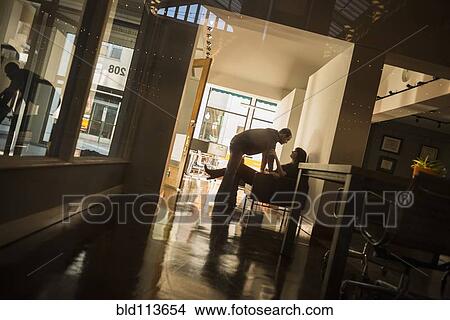 Caucasian couple talking in hallway View Large Photo Image Picture - Caucasian couple talking in hallway. Fotosearch