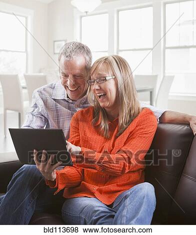 Caucasian couple using tablet computer View Large Photo Image Stock Photo - Caucasian couple using tablet computer. Fotosearch