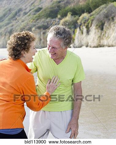 Caucasian couple walking on beach View Large Photo Image Stock Image - Caucasian couple walking on beach. Fotosearch