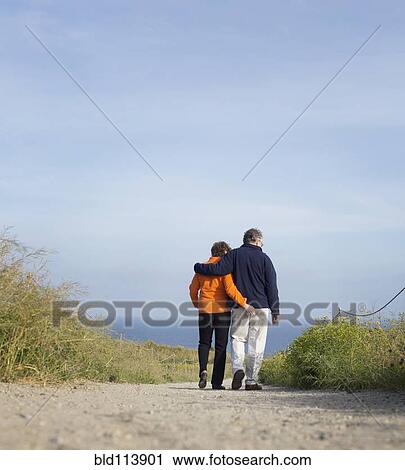 Caucasian couple walking on beach View Large Photo Image Stock Image - Caucasian couple walking on beach. Fotosearch