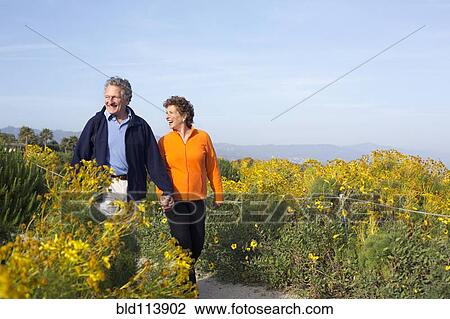 Caucasian couple walking on beach View Large Photo Image Stock Image - Caucasian couple walking on beach. Fotosearch
