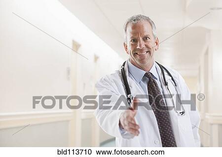 Caucasian doctor offering handshake View Large Photo Image Stock Image - Caucasian doctor offering handshake. Fotosearch
