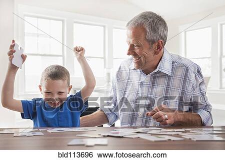 Caucasian father and son playing cards View Large Photo Image Stock Photograph - Caucasian father and son playing cards. Fotosearch
