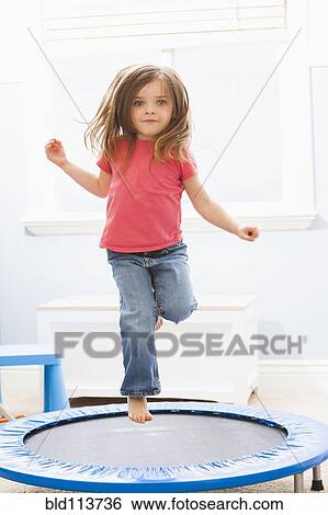 Caucasian girl jumping on trampoline View Large Photo Image Stock Photograph - Caucasian girl jumping on trampoline. Fotosearch