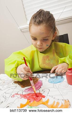 Caucasian girl painting at table View Large Photo Image Stock Photo - Caucasian girl painting at table. Fotosearch