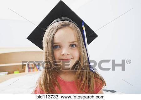 Stock Image - Caucasian girl wearing graduate cap. Fotosearch
