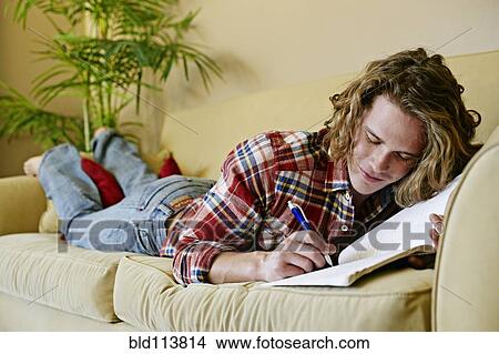 Picture - Caucasian man drawing on sofa. Fotosearch