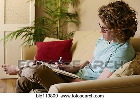 Caucasian man drawing on sofa View Large Photo Image Stock Photo - Caucasian man drawing on sofa. Fotosearch
