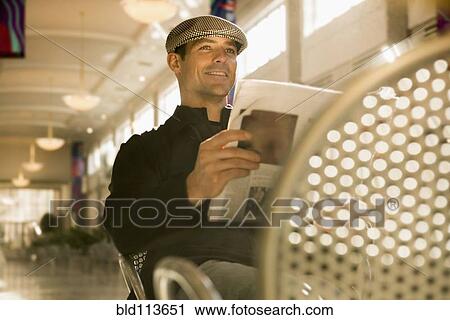 Caucasian man reading newspaper in cafe View Large Photo Image Stock Image - Caucasian man reading newspaper in cafe. Fotosearch