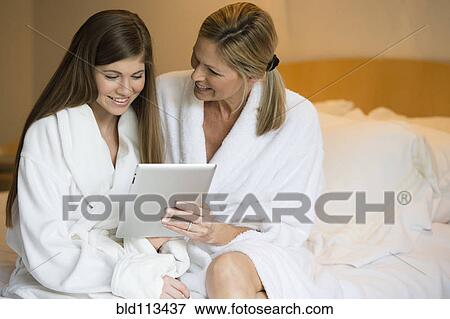 Caucasian mother and daughter using tablet computer View Large Photo Image Stock Photo - Caucasian mother and daughter using tablet computer. Fotosearch