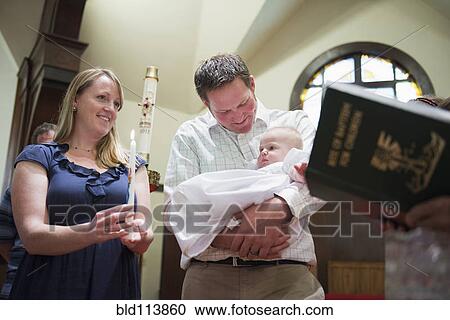 Caucasian parents having baby baptized in church View Large Photo Image Stock Image - Caucasian parents having baby baptized in church. Fotosearch
