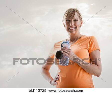Caucasian woman drinking water bottle View Large Photo Image Stock Photography - Caucasian woman drinking water bottle. Fotosearch