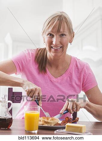 Caucasian woman having breakfast View Large Photo Image Picture - Caucasian woman having breakfast. Fotosearch