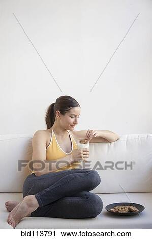 Caucasian woman having milk and cookies View Large Photo Image Stock Image - Caucasian woman having milk and cookies. Fotosearch