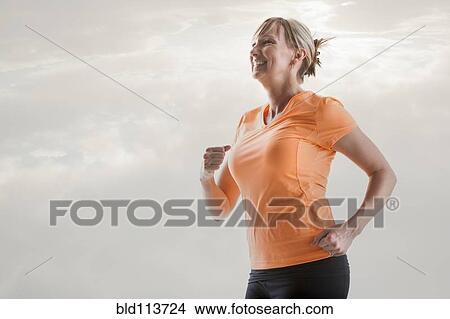 Picture - Caucasian woman running. Fotosearch
