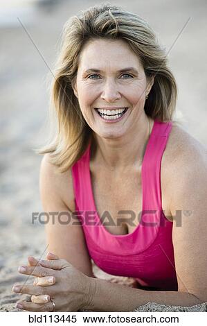 Stock Photography - Caucasian woman smiling on beach. Fotosearch