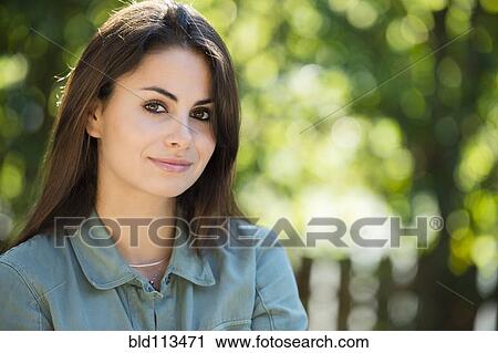 Stock Image - Caucasian woman smiling outdoors. Fotosearch