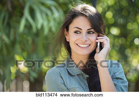 Picture - Caucasian woman talking on cell phone. Fotosearch