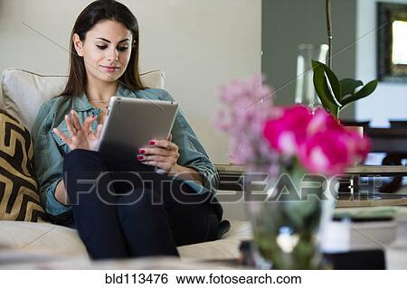 Stock Photograph - Caucasian woman using tablet computer. Fotosearch