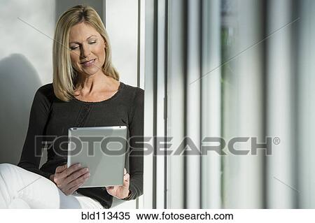 Caucasian woman using tablet computer View Large Photo Image Stock Photography - Caucasian woman using tablet computer. Fotosearch