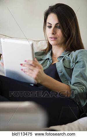 Stock Photography - Caucasian woman using tablet computer. Fotosearch