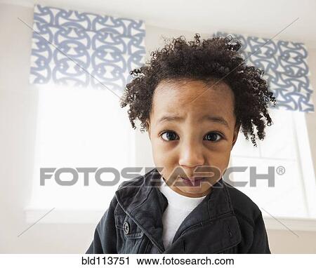 Stock Image - Close up of mixed race boy's face. Fotosearch