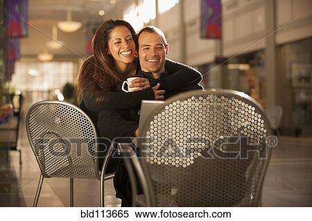 Couple hugging in shopping mall View Large Photo Image Stock Photography - Couple hugging in shopping mall. Fotosearch