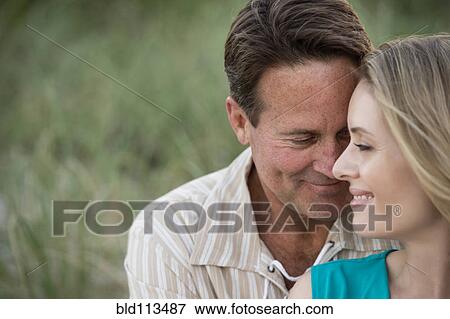 Stock Photo - Couple hugging outdoors. Fotosearch
