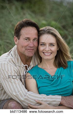 Stock Photograph - Couple hugging outdoors. Fotosearch