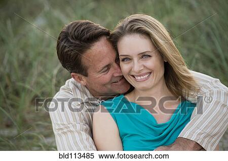 Stock Photography - Couple hugging outdoors. Fotosearch
