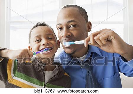 Father and son brushing their teeth View Large Photo Image Stock Photo - Father and son brushing their teeth. Fotosearch