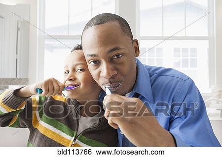 Father and son brushing their teeth View Large Photo Image Stock Photograph - Father and son brushing their teeth. Fotosearch