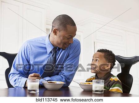 Father and son having breakfast together View Large Photo Image Stock Photography - Father and son having breakfast together. Fotosearch