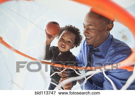 Father and son playing basketball together View Large Photo Image Stock Photo - Father and son playing basketball together. Fotosearch