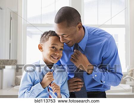 Father and son straightening their ties View Large Photo Image Stock Image - Father and son straightening their ties. Fotosearch