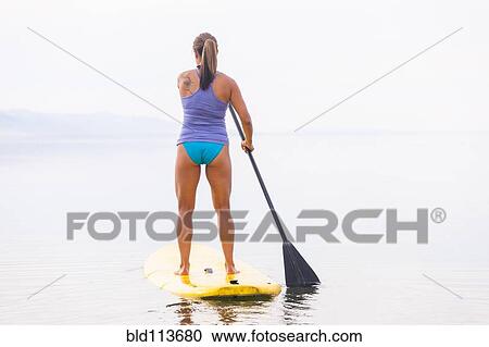 Filipino woman riding paddle board View Large Photo Image Stock Image - Filipino woman riding paddle board. Fotosearch