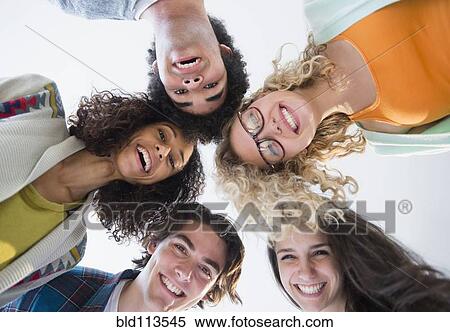 Friends huddled in circle together View Large Photo Image Stock Photography - Friends huddled in circle together. Fotosearch