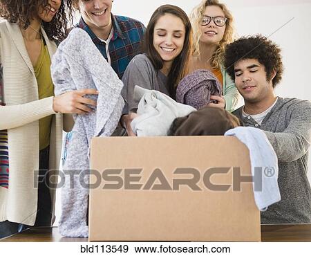 Stock Photo - Friends packing boxes together. Fotosearch