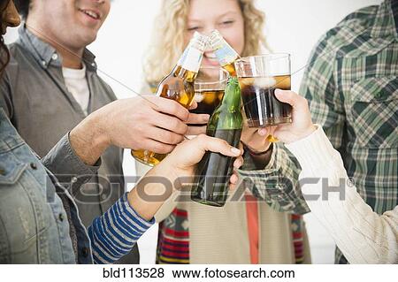 Stock Photo - Friends toasting each other at party. Fotosearch