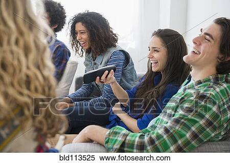Friends watching television together View Large Photo Image Stock Photography - Friends watching television together. Fotosearch