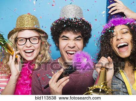 Stock Photo - Friends wearing hats at party. Fotosearch
