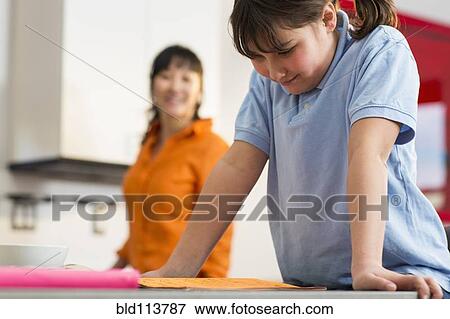 Girl reading homework at desk View Large Photo Image Stock Photo - Girl reading homework at desk. Fotosearch