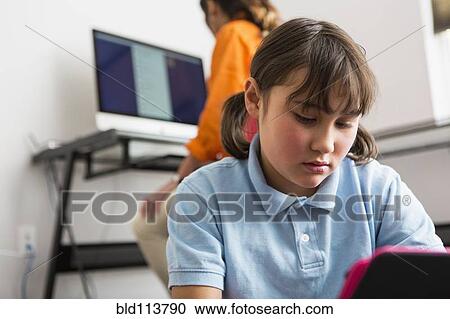 Girl using tablet computer View Large Photo Image Stock Image - Girl using tablet computer. Fotosearch
