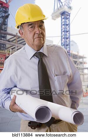 Hispanic businessman carrying blueprints View Large Photo Image Picture - Hispanic businessman carrying blueprints. Fotosearch