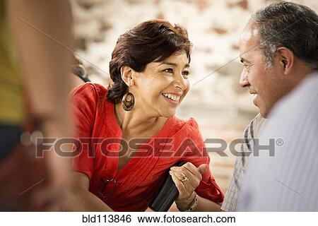 Stock Photograph - Hispanic couple talking outdoors. Fotosearch