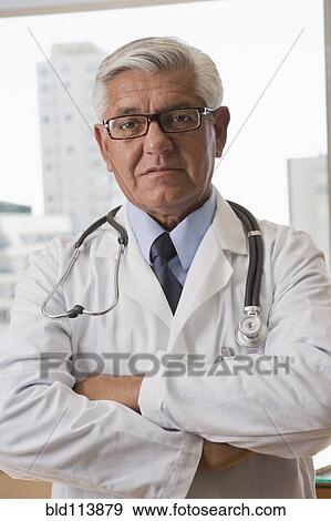 Stock Photo - Hispanic doctor standing with arms crossed. Fotosearch