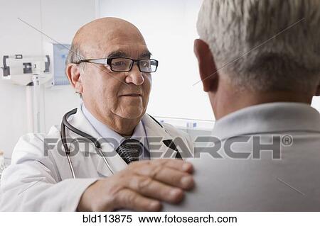 Stock Photography - Hispanic doctor talking with patient. Fotosearch